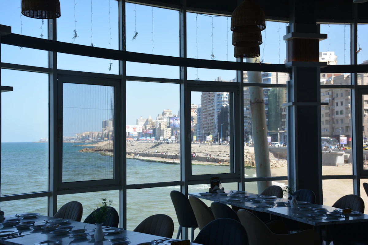 Tall windows in the dining room looking out over the sea and the harbour wall